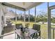 Relaxing screened patio with outdoor furniture and peaceful views of the pond and backyard at 281 Jackson St, Goose Creek, SC 29445