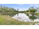 Picturesque view of a pond reflecting the sky, surrounded by lush greenery and trees at 281 Jackson St, Goose Creek, SC 29445