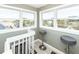 Bright attic space featuring two bar stools and beautiful views out of the window at 3013 Middle St, Sullivans Island, SC 29482