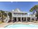 Gorgeous backyard with a sparkling pool, patio area, and lush landscaping for ultimate relaxation at 3013 Middle St, Sullivans Island, SC 29482