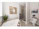 Relaxing bathroom featuring a soaking tub, a separate shower, and elegant décor at 3013 Middle St, Sullivans Island, SC 29482
