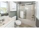 Bathroom features a tub with sliding glass doors and a white sink and cabinet at 3013 Middle St, Sullivans Island, SC 29482