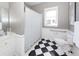 A bathroom with black and white tile flooring and a shower with a patterned curtain at 3013 Middle St, Sullivans Island, SC 29482