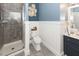 Well-lit bathroom featuring a glass enclosed shower and stylish wainscoting and decor at 3013 Middle St, Sullivans Island, SC 29482