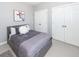 Neutral bedroom showcasing a queen-size bed, modern art, plush pillows, and double closets at 3013 Middle St, Sullivans Island, SC 29482