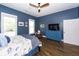A comfortable bedroom with blue walls, hardwood floors, and modern ceiling fan at 3013 Middle St, Sullivans Island, SC 29482