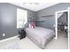 Cozy bedroom with modern gray walls, floating shelves, and a comfortable bed at 3013 Middle St, Sullivans Island, SC 29482