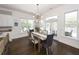 Bright dining room with modern chandelier, white shiplap walls, and lots of natural light at 3013 Middle St, Sullivans Island, SC 29482