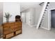 Bright hallway with wood dresser, carpet and stairs leading up at 3013 Middle St, Sullivans Island, SC 29482