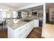 Open concept kitchen with granite countertops, stainless appliances, and seamless access to dining and living areas at 3013 Middle St, Sullivans Island, SC 29482