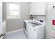 Efficient laundry room with modern washer/dryer, storage cabinets, and a view from the window at 3013 Middle St, Sullivans Island, SC 29482
