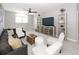 Bright living room with stylish furniture, decorative shelving, and a ceiling fan at 3013 Middle St, Sullivans Island, SC 29482