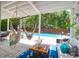 Relaxing covered patio overlooking the pool with comfortable lounge furniture at 3013 Middle St, Sullivans Island, SC 29482