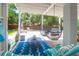 Stylish covered patio with hanging chairs and comfortable seating near the pool at 3013 Middle St, Sullivans Island, SC 29482