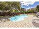 Backyard with a private pool, brick patio, lounge seating, and surrounded by lush trees at 3013 Middle St, Sullivans Island, SC 29482
