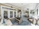 Relaxing screened porch with comfortable seating, perfect for outdoor entertaining at 3013 Middle St, Sullivans Island, SC 29482
