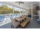 A charming screened porch with a dining table and ample seating for relaxation and entertaining at 3013 Middle St, Sullivans Island, SC 29482