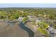 Stunning aerial view showcases a home with a private dock on a winding waterway surrounded by marsh and trees at 3104 Upda Creek, Seabrook Island, SC 29455