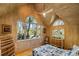 Bedroom with vaulted wood ceilings and large windows with views at 3104 Upda Creek, Seabrook Island, SC 29455