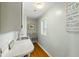 Bright laundry room featuring modern sink, white cabinets, wood-style floors, and plenty of natural light at 3104 Upda Creek, Seabrook Island, SC 29455