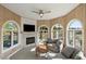 Cozy sitting area with large arched windows, a fireplace, and scenic marsh views at 3104 Upda Creek, Seabrook Island, SC 29455