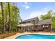 Expansive backyard with a pool, outdoor kitchen, screened-in porch, and manicured landscaping at 312 E Shepard Ln, Summerville, SC 29483