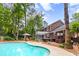 Beautiful backyard with a pool, outdoor kitchen, pergola, screened-in porch, and ample space for entertaining at 312 E Shepard Ln, Summerville, SC 29483