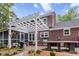Stunning brick home featuring a white pergola, an outdoor kitchen, and a screened-in porch at 312 E Shepard Ln, Summerville, SC 29483