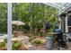 Beautifully landscaped backyard features a stone path leading to an outdoor dining area and barbecue grill at 312 E Shepard Ln, Summerville, SC 29483