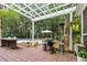 Inviting backyard patio with outdoor cooking area and nearby pool, shaded by a charming pergola at 312 E Shepard Ln, Summerville, SC 29483