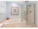 Bathroom featuring a soaking tub with jets, a shower with a glass door, and a small plant at 312 E Shepard Ln, Summerville, SC 29483