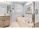 Bathroom featuring a soaking tub with jets, a shower with a glass door, and a large vanity with a mirror at 312 E Shepard Ln, Summerville, SC 29483