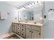 Bathroom featuring double sinks with a large vanity, a towel rack, a large mirror and a floral rug at 312 E Shepard Ln, Summerville, SC 29483