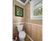 Bathroom with toilet, wood paneling and wall art at 312 E Shepard Ln, Summerville, SC 29483