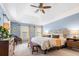 Bright bedroom boasts light blue walls, ceiling fan and natural light from the windows at 312 E Shepard Ln, Summerville, SC 29483