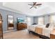 Bedroom showcasing a king bed, tall mirror, ceiling fan, and natural light at 312 E Shepard Ln, Summerville, SC 29483