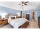 Bright blue bedroom with ceiling fan and ensuite bathroom and large bed at 312 E Shepard Ln, Summerville, SC 29483