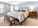 Bedroom featuring blue walls, a seating bench, and natural light from the windows at 312 E Shepard Ln, Summerville, SC 29483