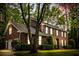 Stately brick home featuring manicured landscaping, symmetrical design, and an inviting entrance at 312 E Shepard Ln, Summerville, SC 29483