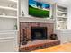 Close up of a brick fireplace with a mounted television and built-in shelving at 312 E Shepard Ln, Summerville, SC 29483