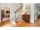 Welcoming foyer with hardwood floors, elegant staircase, and stylish decorative mirror at 312 E Shepard Ln, Summerville, SC 29483
