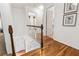 Hallway features hardwood floors and white trim and access to rooms on the second story at 312 E Shepard Ln, Summerville, SC 29483