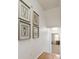 Hallway with hardwood flooring and framed botanical prints at 312 E Shepard Ln, Summerville, SC 29483