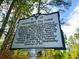 Historical marker sign for the Pinehurst Tea Farm, under a canopy of green trees at 312 E Shepard Ln, Summerville, SC 29483