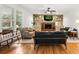 Bright living room with fireplace, built-in shelves, and ample natural light from large windows at 312 E Shepard Ln, Summerville, SC 29483