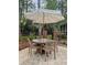 Outdoor dining set with an umbrella provides a shaded area for enjoying meals on the patio at 312 E Shepard Ln, Summerville, SC 29483
