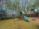 Backyard playground set with a swing, a slide, and a treehouse for outdoor fun at 312 E Shepard Ln, Summerville, SC 29483