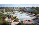 Expansive community pool featuring slides, lounge chairs, umbrellas, and lush landscaping at 314 Archar St, Summerville, SC 29486