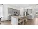 Bright kitchen featuring a large granite island with seating and stainless steel appliances at 314 Archar St, Summerville, SC 29486