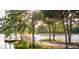 Beautiful view of a dog at the pond featuring a wooden dock and surrounding greenery at 314 Archar St, Summerville, SC 29486